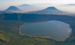 Empakai crater and lake, in the background Ol Doinyo Lengai (left) and Keremasi (right), aerial view, Tanzania
